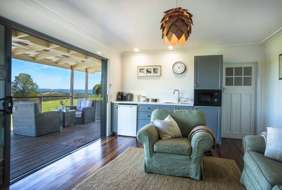 Sink into the comfy country couch and bring the outdoors in with the sliding doors opening onto the deck.