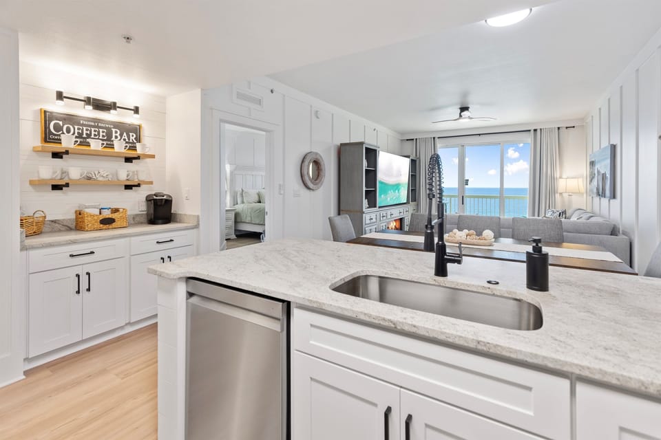 Your modern kitchen features granite countertops and ocean views while you prepare meals with stunning sea vistas as your backdrop.