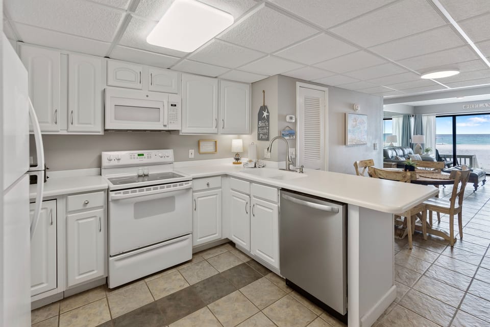 Your fully equipped kitchen features modern appliances and ocean views, perfect for preparing meals while enjoying the coastal scenery.