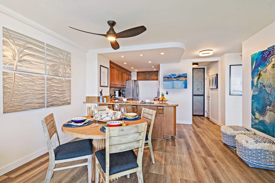 Dining and kitchen combination with a spacious layout, stylish lighting, and natural wood finishes.