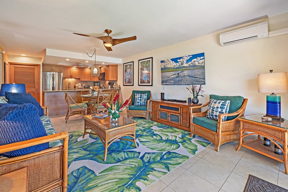 Enjoy an open-concept living space with comfortable seating, colorful accents, and easy access to the kitchen.