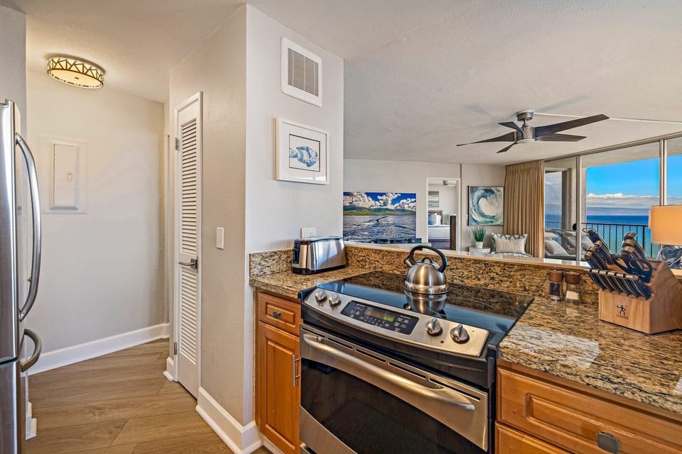 Well‑equipped kitchen featuring warm wood cabinetry and stainless‑steel appliances.