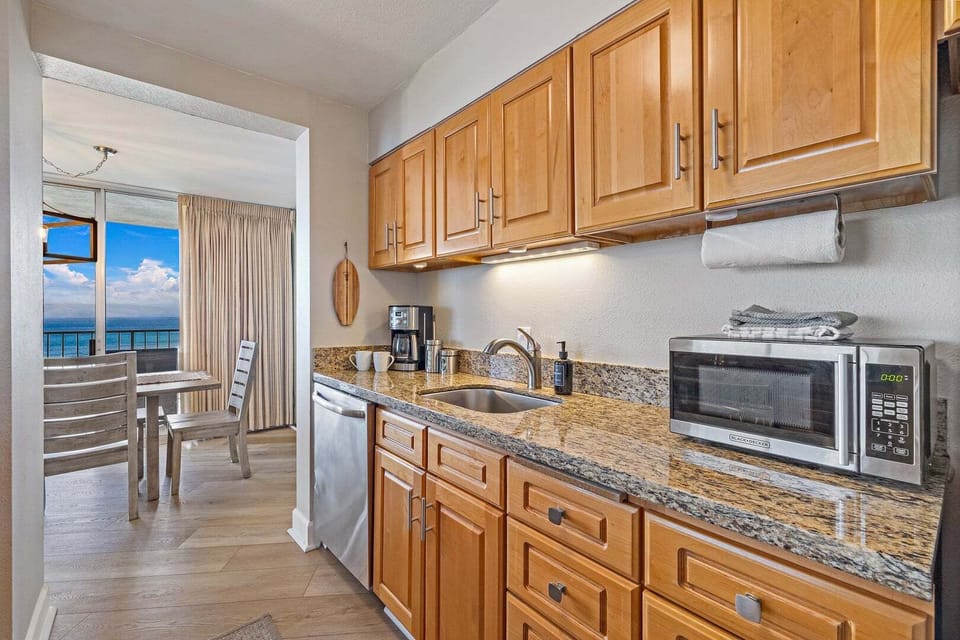 Updated kitchen with full appliances, granite counters, and easy access to the lanai.