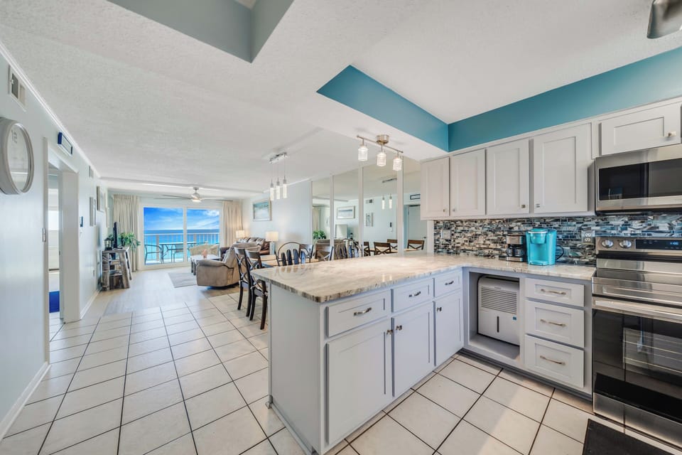 The updated, fully equipped kitchen features quartz countertops, stainless-steel appliances, and has everything you need to prepare meals for family & friends.
