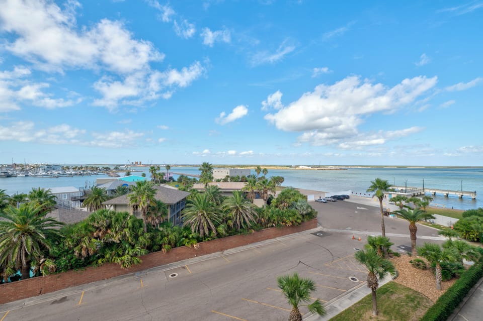 Panoramic coastal view showcasing waterfront properties, marina, and tropical landscaping in this scenic area.
