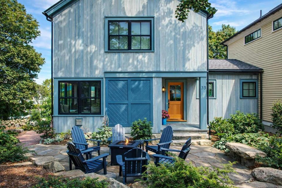 Charming exterior with blue doors and welcoming garden patio