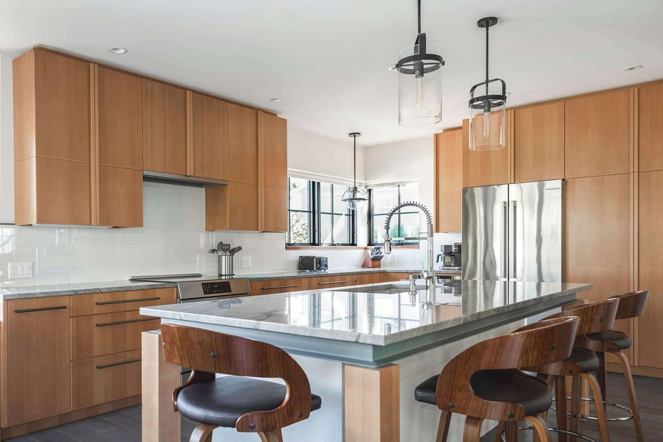 Chef's kitchen with warm wood cabinetry and stainless steel appliances