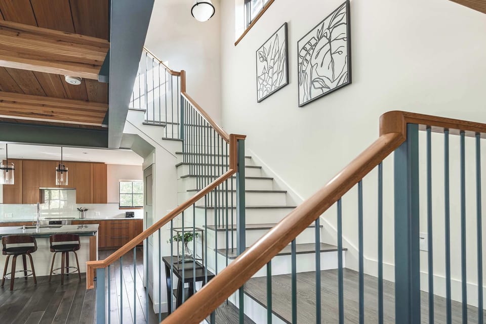 Soaring staircase showcases architectural detail and bright interiors