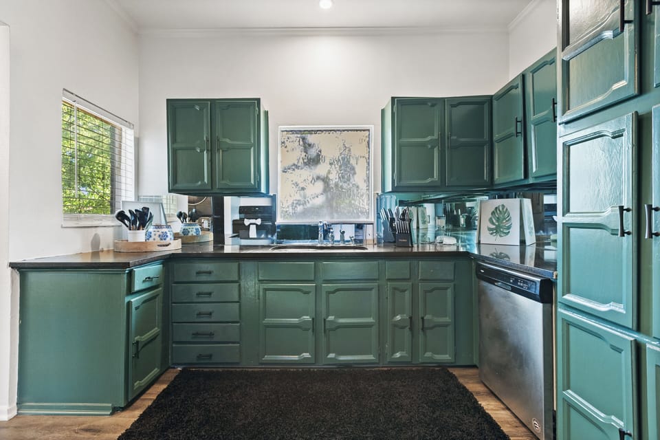 A spacious kitchen featuring top-of-the-line, full-size modern appliances, thoughtfully selected to make meal preparation both seamless and effortless.