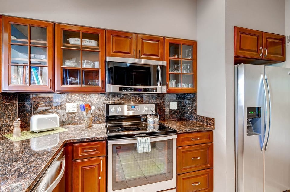 A chef’s delight—ample counter space, modern appliances, and warm wood cabinetry make cooking effortless.