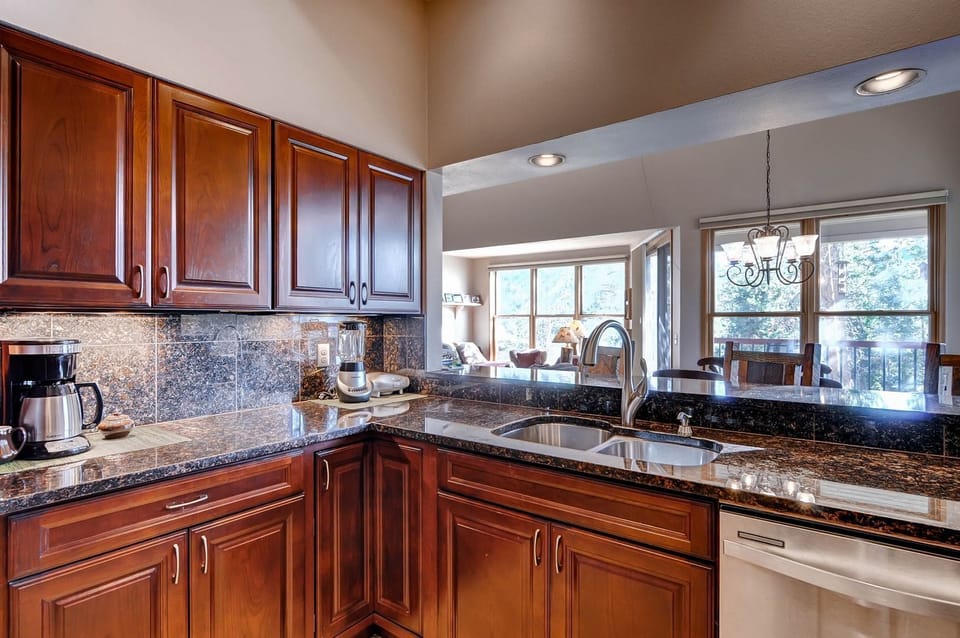 Fully equipped kitchen with granite counters, stainless appliances, and all the essentials for home-cooked meals.