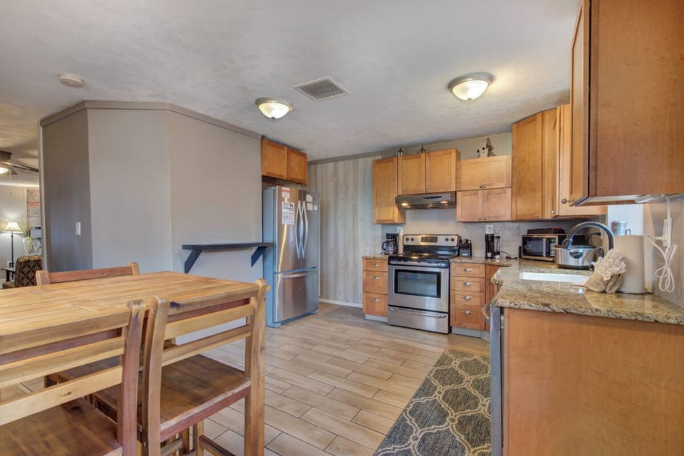 Your spacious kitchen features granite counters, stainless appliances, and plenty of cabinet storage for preparing memorable meals during your stay.