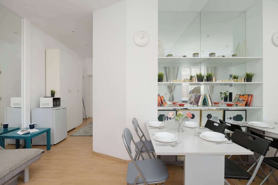 The mirrored wall and bright finishes make the interior feel exceptionally spacious, giving guests a soothing place to work and relax.
