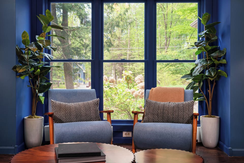 Window-side reading nook with cozy, sunlit seating