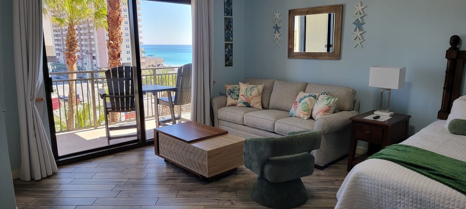 Unwind in your ocean-view suite with plush seating and a private balcony overlooking turquoise waters and swaying palms.
