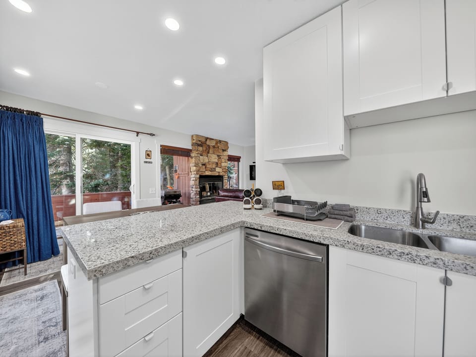 Step into your modern kitchen where white cabinets and granite counters create the perfect space for cooking memorable meals.