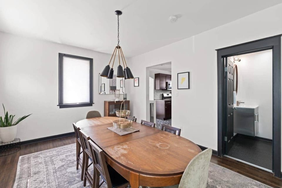 Open-concept dining and living area with stylish lighting and comfortable seating.
