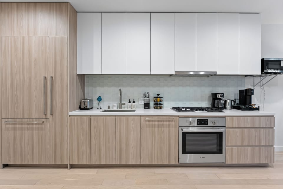 Custom wood cabinetry and stone countertops offer a touch of luxury.