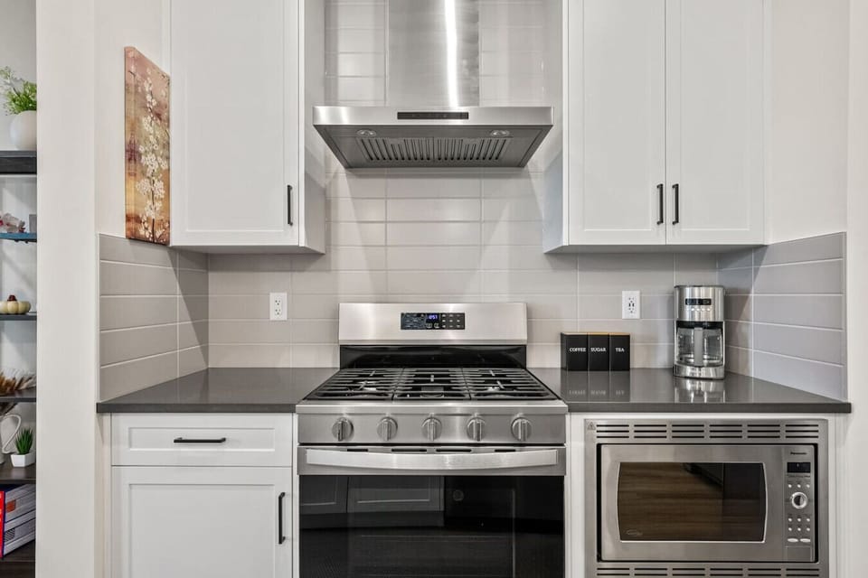 Full kitchen with a drip coffee maker, ground coffee, tea, sugar, basic condiments (ketchup, mustard, relish), and an air fryer.