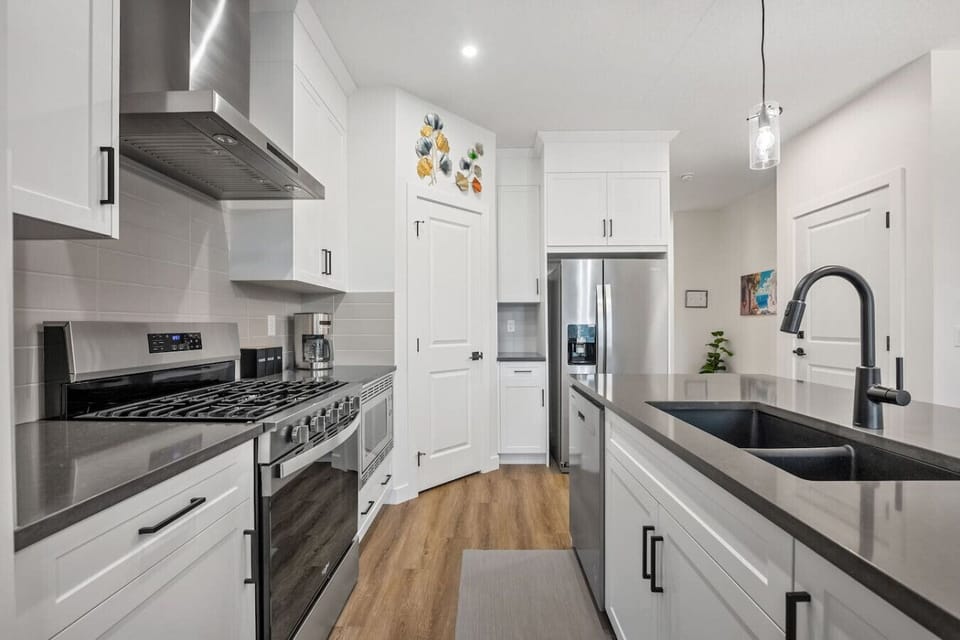 Full kitchen with a drip coffee maker, ground coffee, tea, sugar, basic condiments (ketchup, mustard, relish), and an air fryer.
