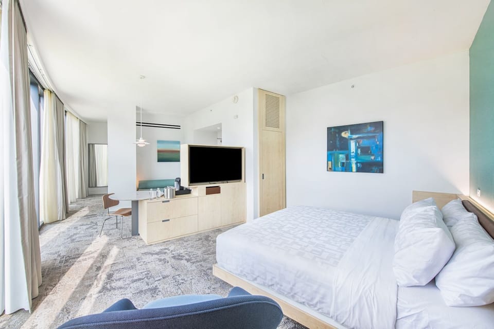 Retreat to this spacious guestroom at Hotel Eleo, where elegant aesthetics and inclusive design invite you to unwind in comfort.