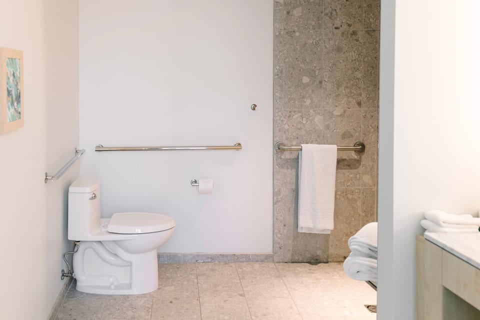 Relax and rejuvenate in this spacious ADA-compliant bathroom, beautifully appointed for both style and function.