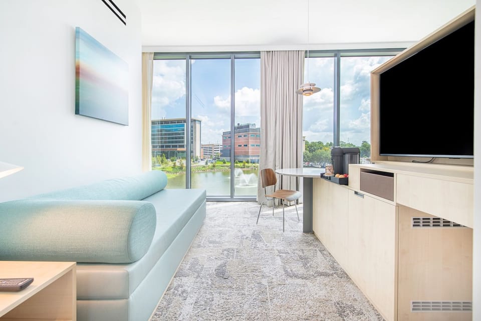 Panoramic lake views blend seamlessly with modern furnishings in this chic living space, perfect for both relaxation and work.