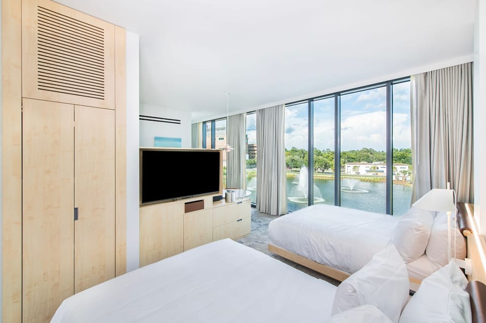 This guestroom invites families to relax in refined comfort, all while enjoying captivating lake views through expansive windows.