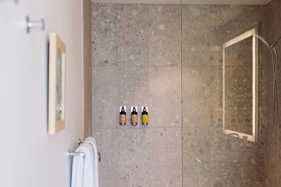 A serene oasis awaits in this modern bathroom, blending style with soothing natural elements.