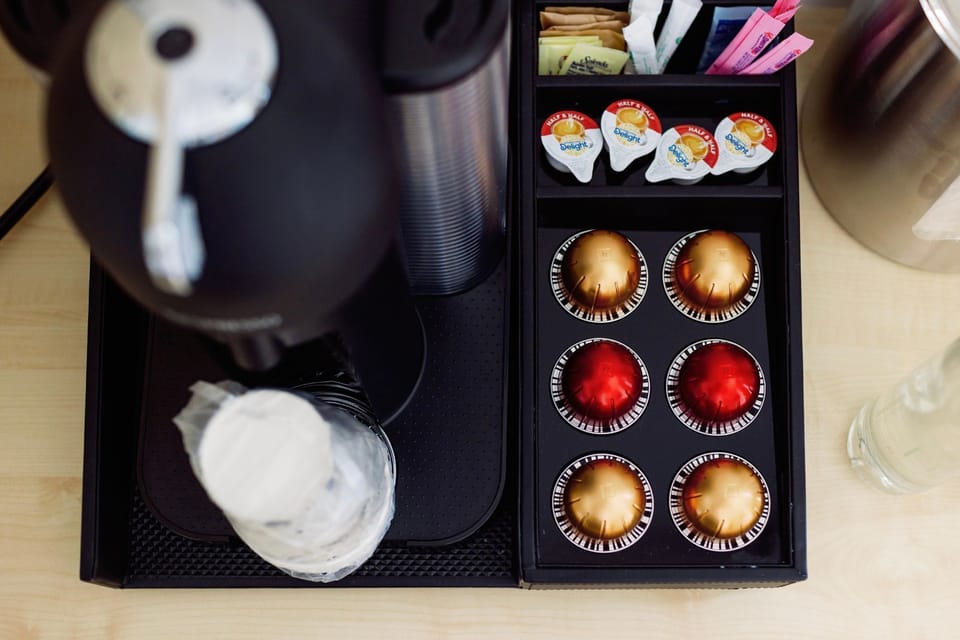 Stylishly arranged, the coffee station offers a convenient touch with premium capsules, blending comfort and elegance.