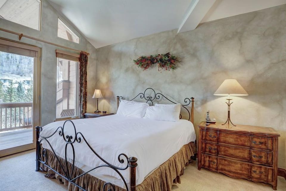 The second king bedroom with vaulted ceilings, large windows, and mountain light.