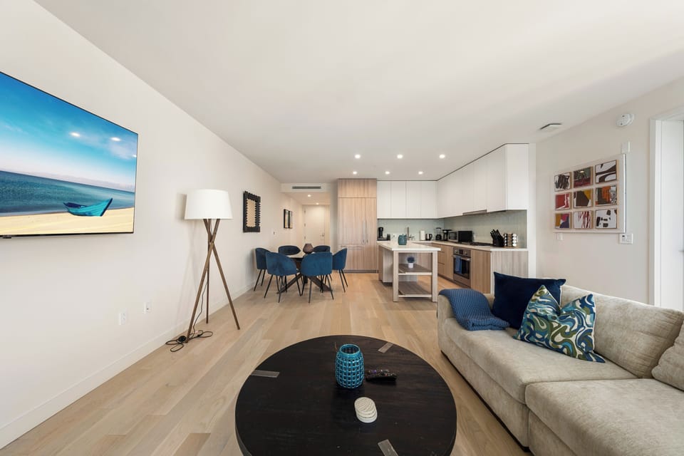 Light oak floors and high ceilings create an airy, upscale feel.