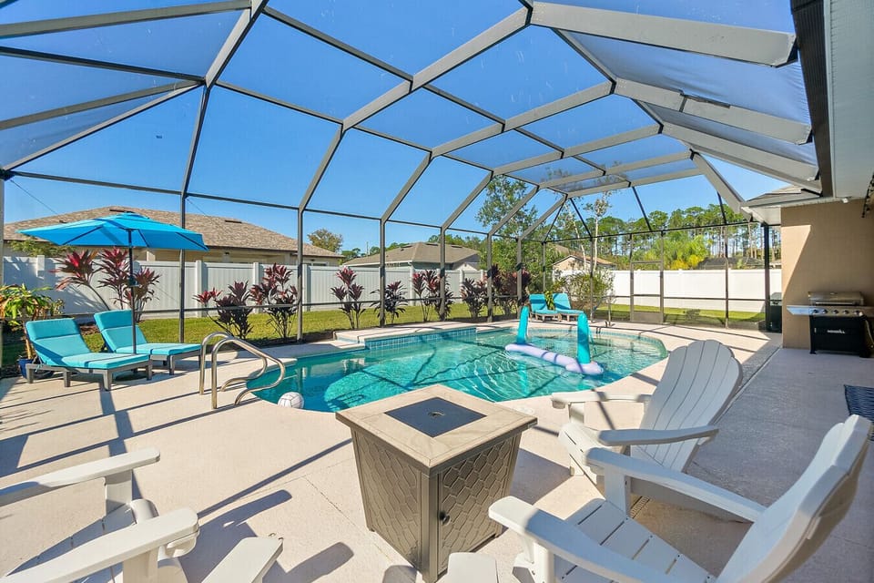 Private screened pool with lounge seating and fenced backyard