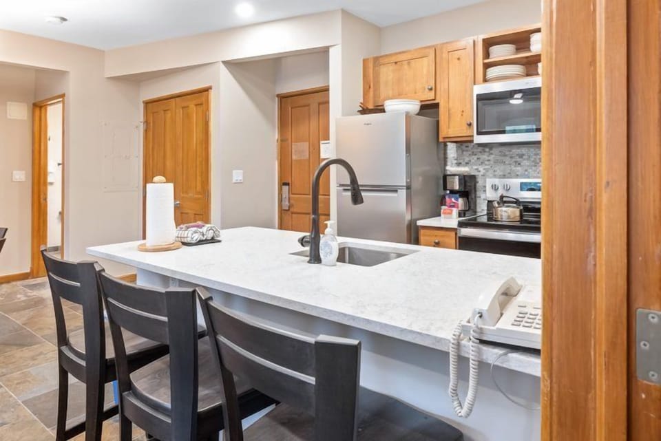 Enjoy casual dining and entertaining at the spacious breakfast bar that seamlessly connects to the inviting kitchen.