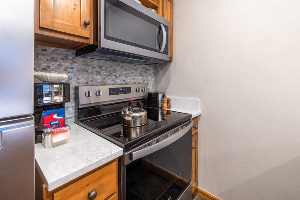 The modern kitchen is equipped with sleek appliances and ample counter space, making it ideal for preparing delicious meals.