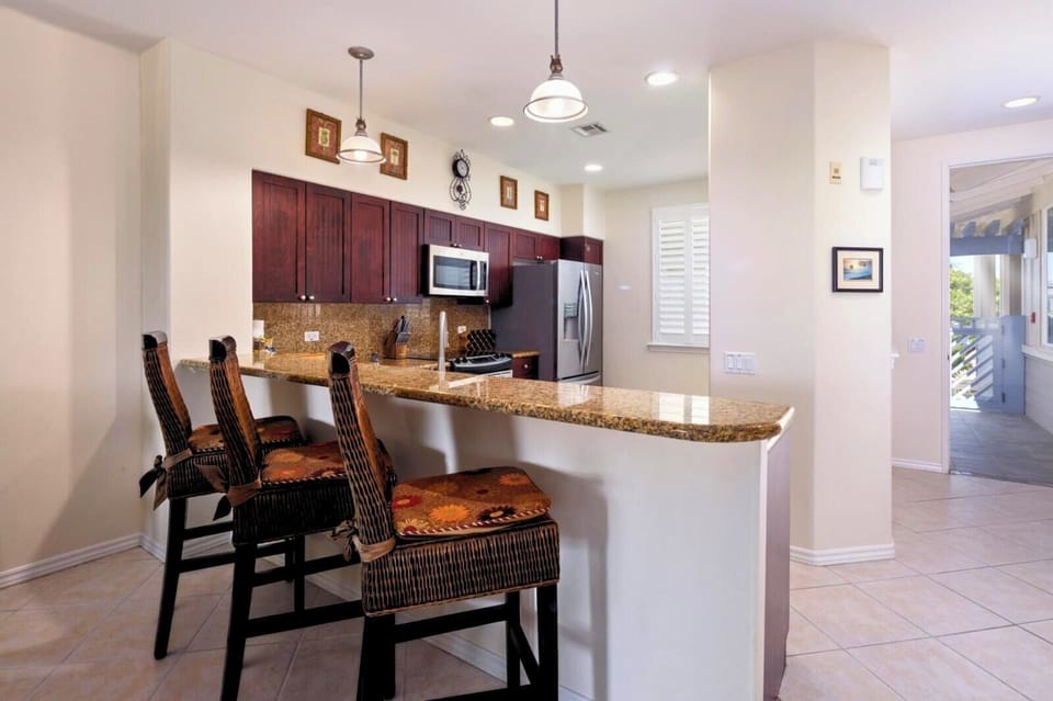 Your kitchen island offers plenty of prep space and seating for quick bites before heading out.