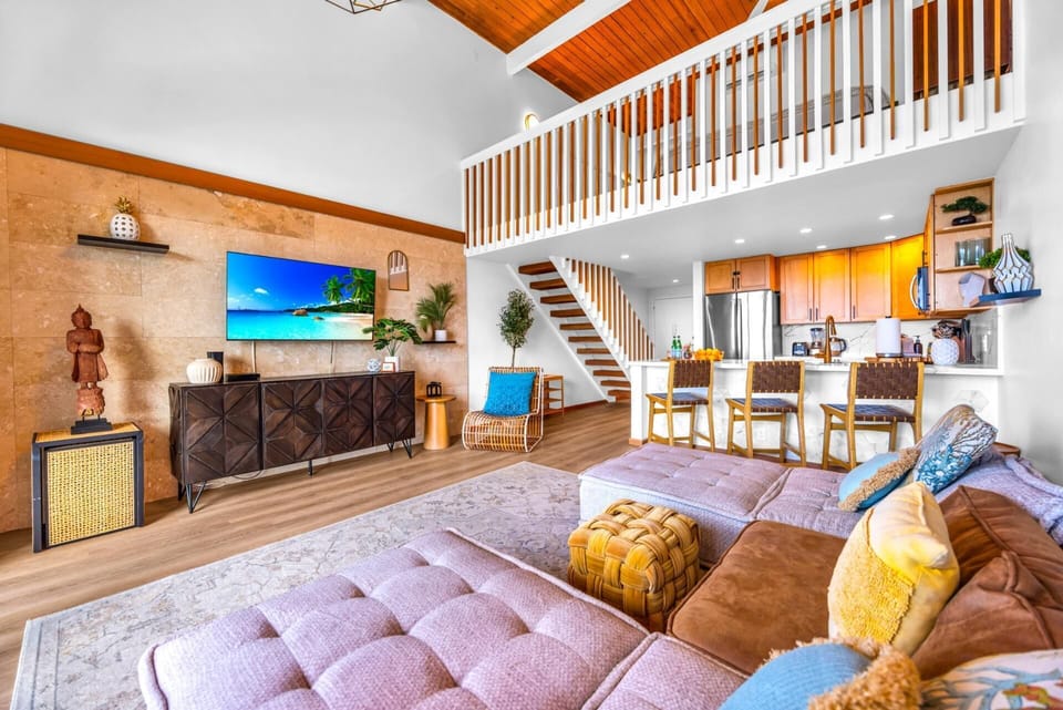 Look up to the loft-style balcony and vaulted ceilings, a striking architectural touch that keeps the living space airy.