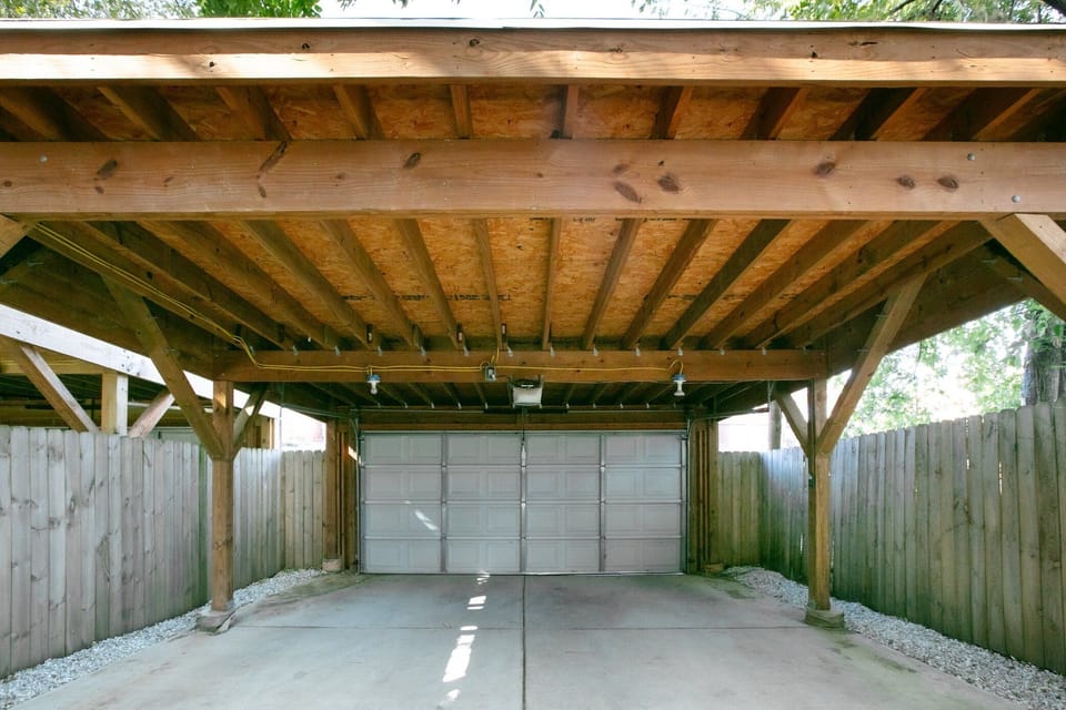 Covered parking with garage door. Can accommodate 2 vehicles.