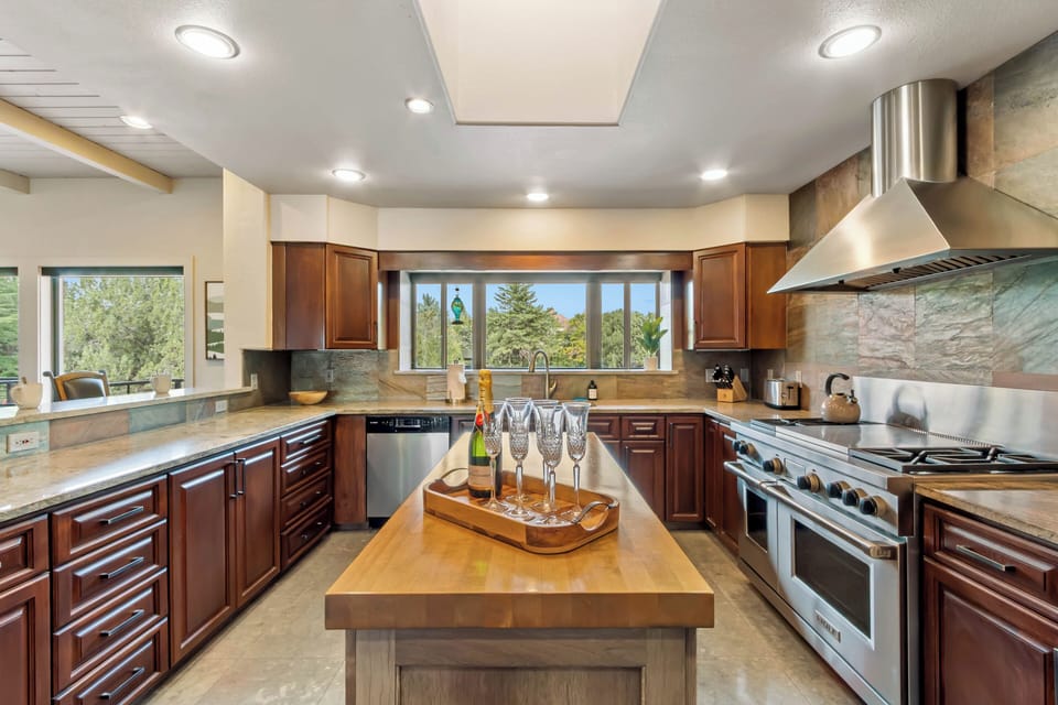 Chefs kitchen with high end appliances and stainless steel appliances.