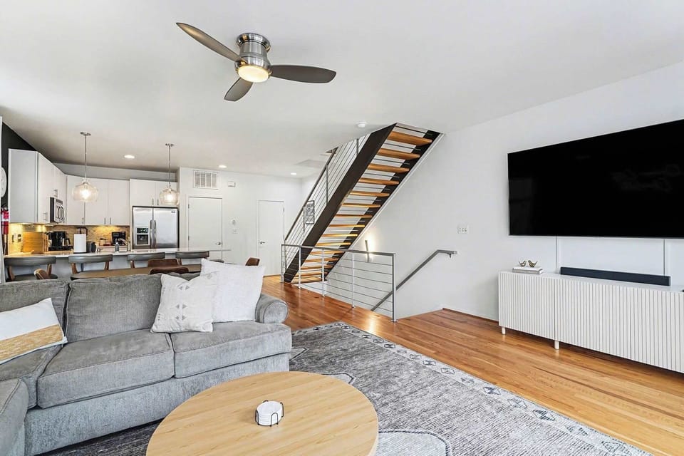 The open second-floor layout seamlessly connects the kitchen and living room, allowing guests to cook, relax, and enjoy each other’s company in one bright, welcoming space.