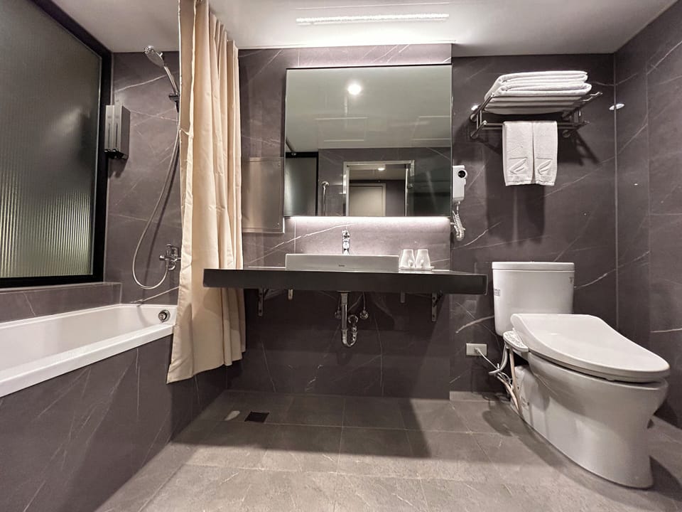 Deluxe Room, 1 Double Bed | Bathroom | Combined shower/tub, hair dryer, slippers, bidet