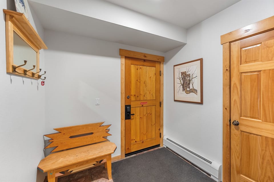 Your private entrance welcomes you with warm wood finishes and mountain-inspired decor, setting the tone for your alpine getaway.