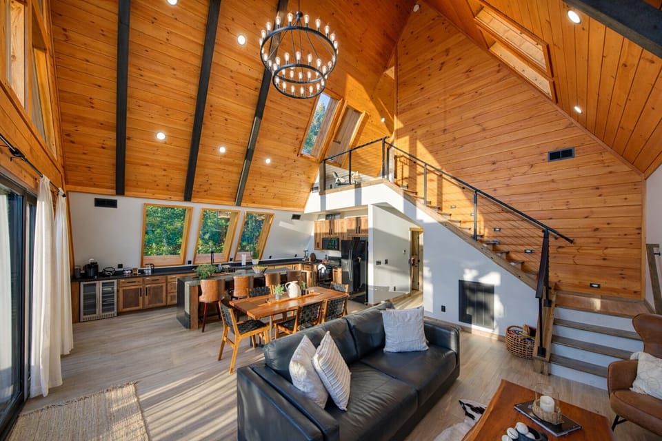 Sunlit open living room with large windows, airy feel, and great views.