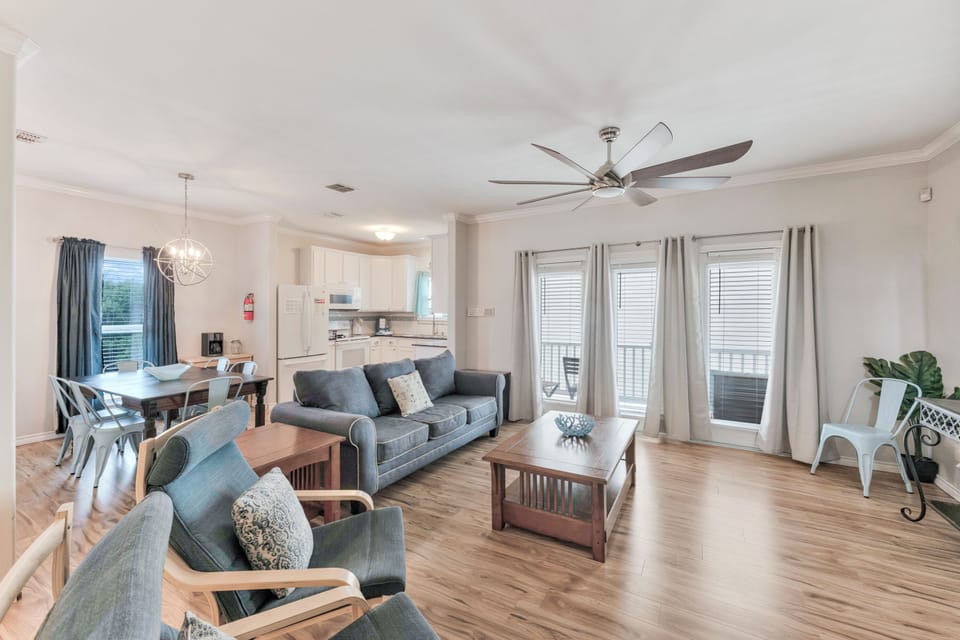 Your bright, open living space flows seamlessly from kitchen to cozy seating, with ceiling fan keeping you comfortable year-round.