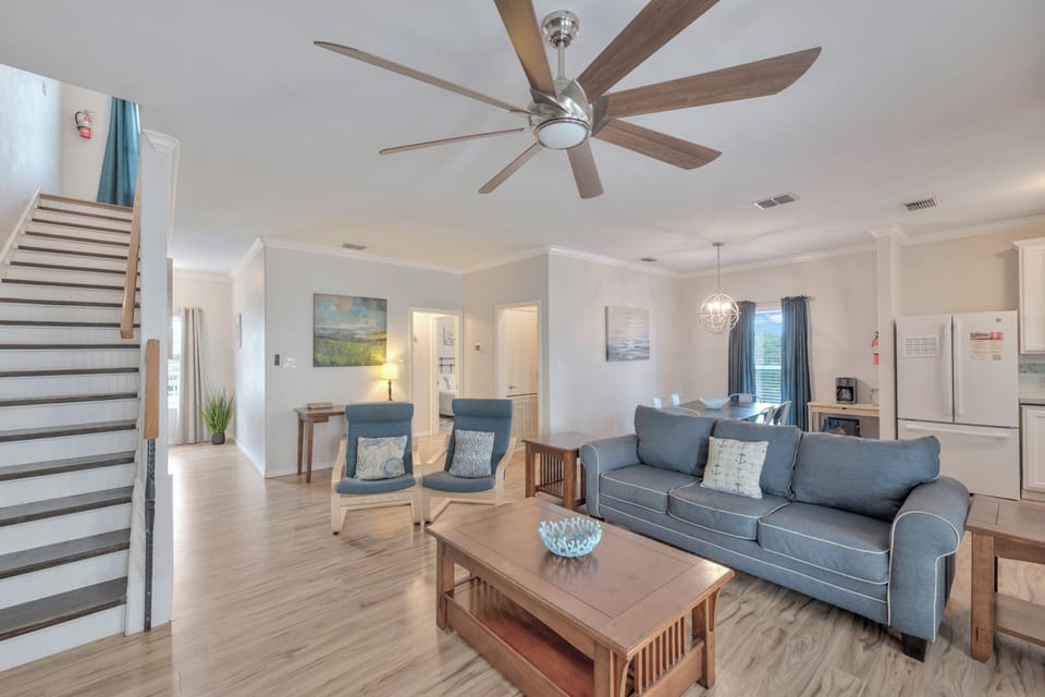 Unwind in your spacious living area featuring plush seating and modern comfort with a ceiling fan to keep you cool.
