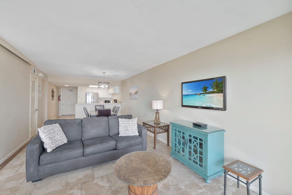 Unwind in your bright, open-concept living space where modern coastal décor meets comfort—perfect for relaxing after beach adventures.