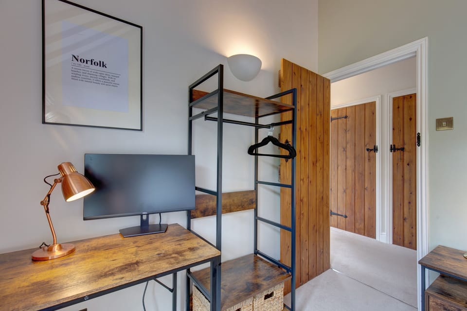 First floor: Bedroom three with dressing table/desk and open wardrobe