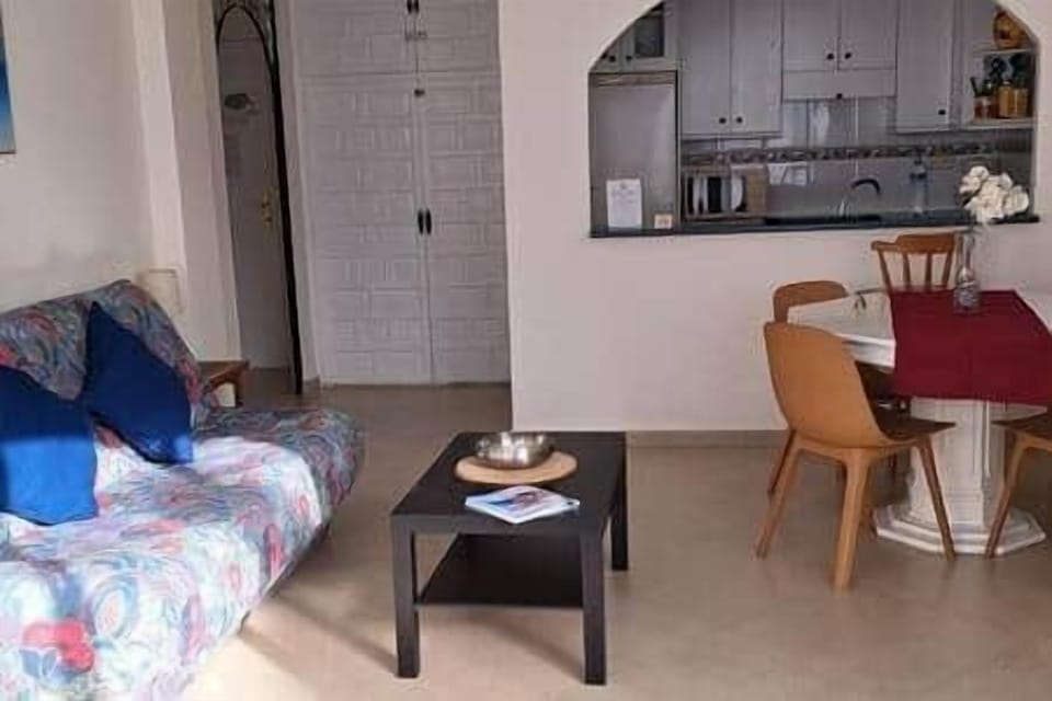 Living room that has a sofa bed that is 130cm wide when opened.