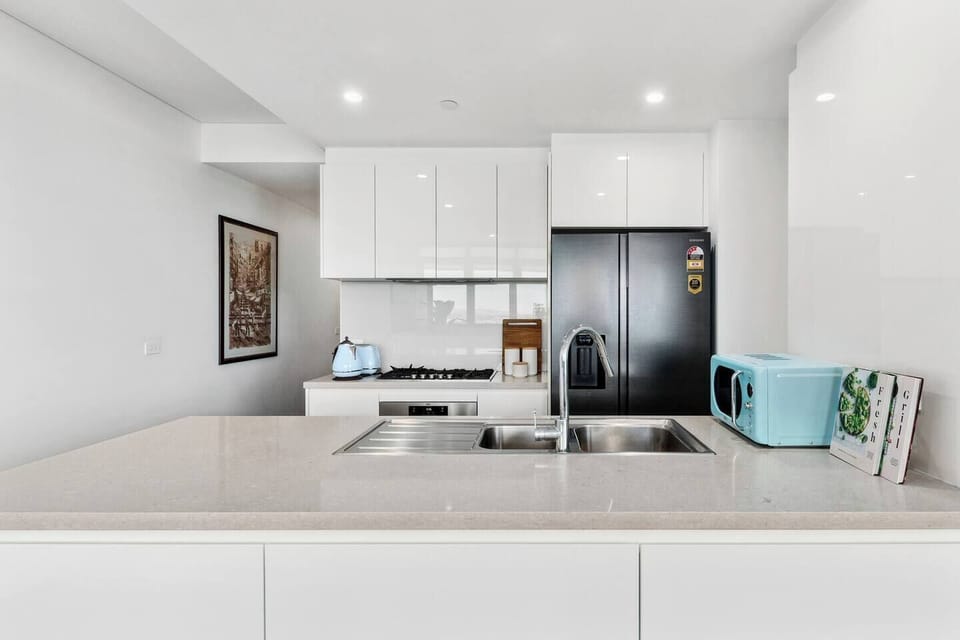 Cook with ease in the sleek kitchen, featuring stainless-steel appliances and everything needed for home-style dining.