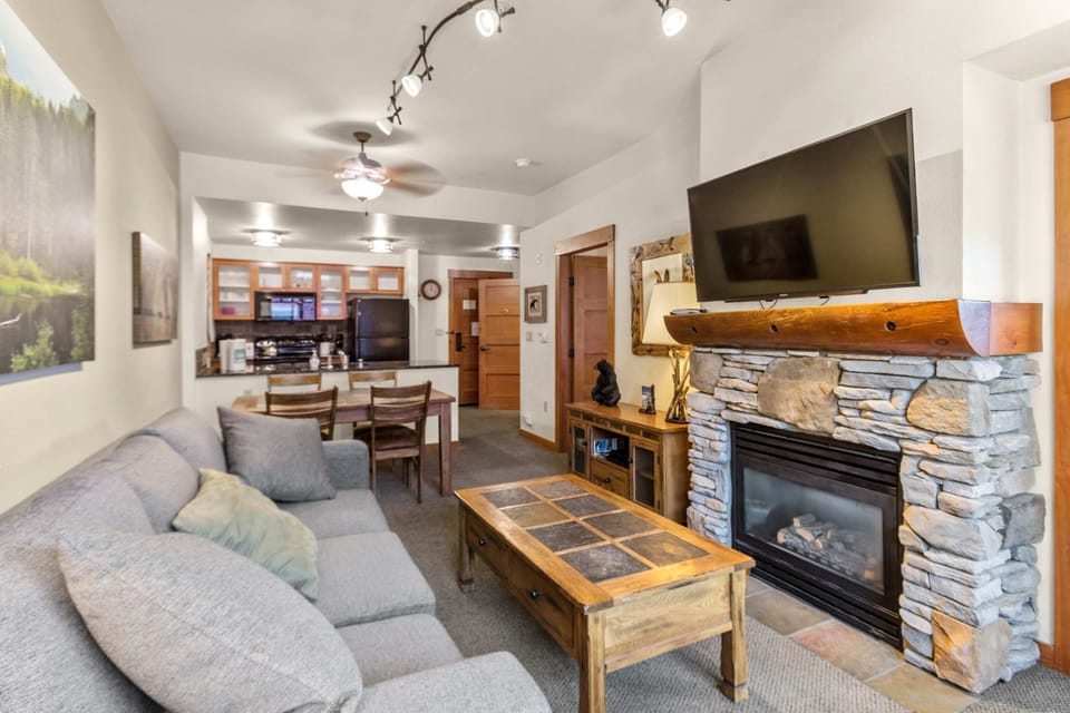 Cozy living area with gas fireplace, Smart TV, and mountain views.